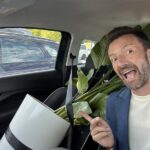 The head of marketing and sales of Spairliners is driving in his car, transporting a new plant for the office in Hamburg.