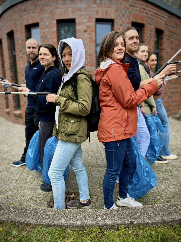 Colleagues picking trash on earth day 2026 Picture of spairliners colleagues in front of our office building equipped with trash bags and tweezers ready to clean up for earth day 2026